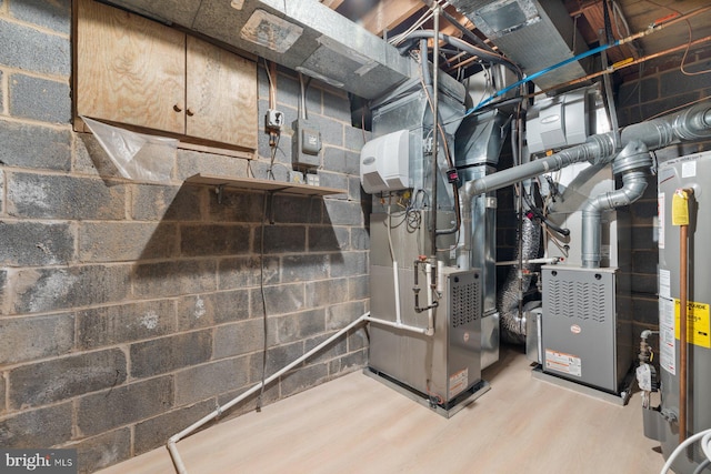 utility room with water heater and heating unit