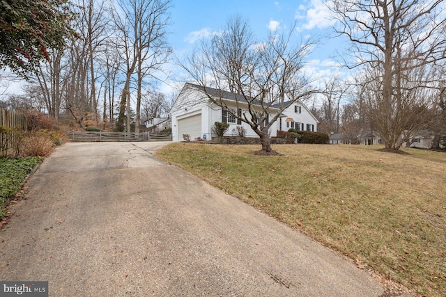 view of front of property featuring a garage and a front lawn