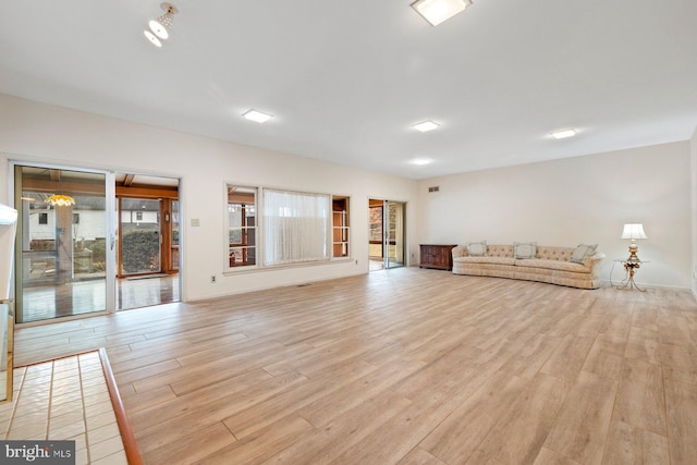 unfurnished living room featuring light hardwood / wood-style flooring