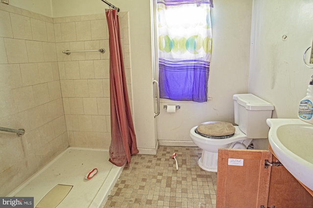 bathroom featuring vanity, toilet, and walk in shower