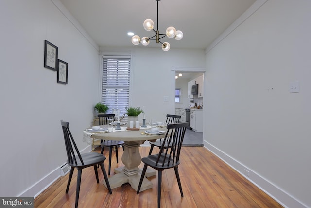 dining room with an inviting chandelier and light hardwood / wood-style floors