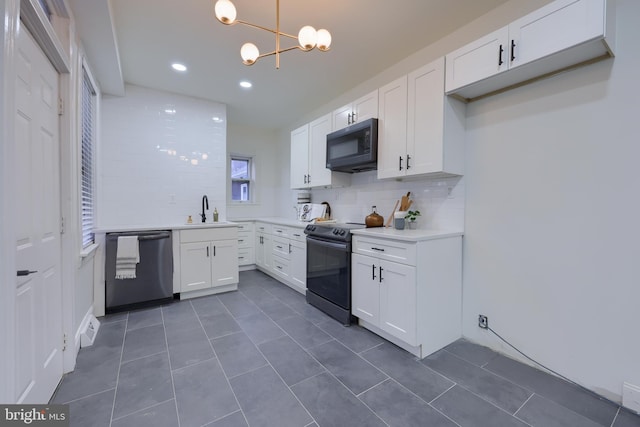 kitchen featuring sink, white cabinetry, decorative light fixtures, dishwashing machine, and electric stove