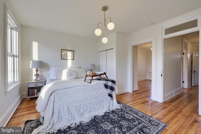 bedroom with light wood-type flooring and a closet