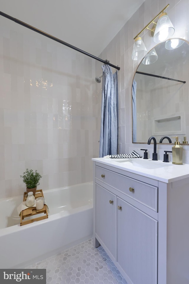 bathroom featuring vanity, tile patterned flooring, and tile walls