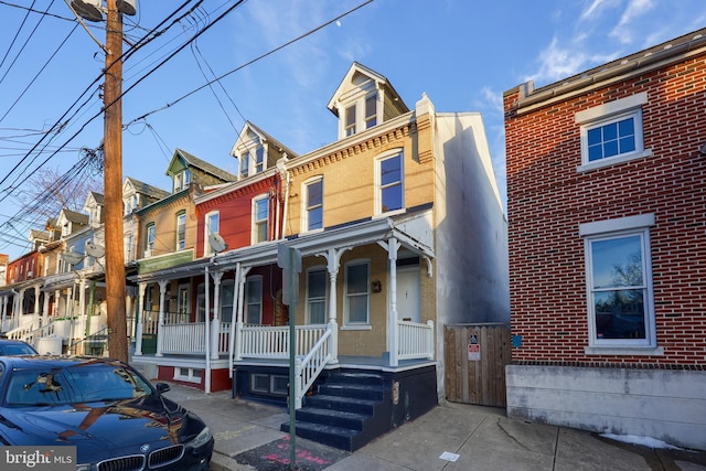 townhome / multi-family property with a porch