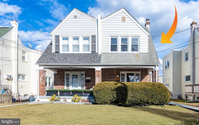 view of front of home featuring a front lawn and a porch