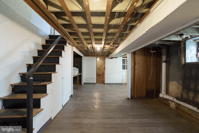 basement with dark hardwood / wood-style floors