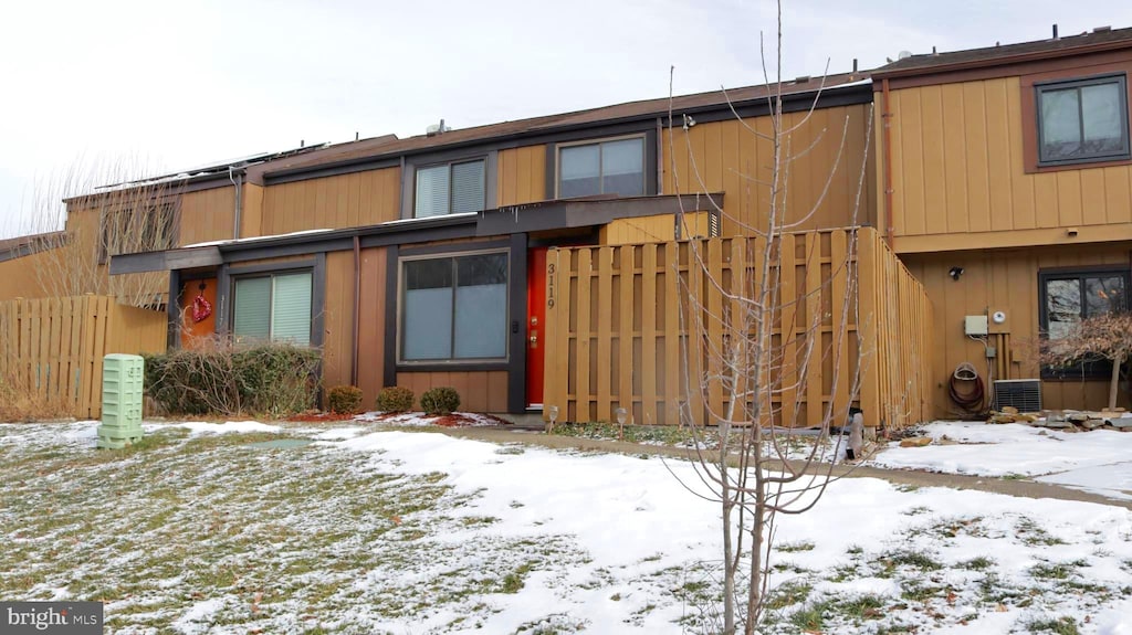 snow covered property with cooling unit