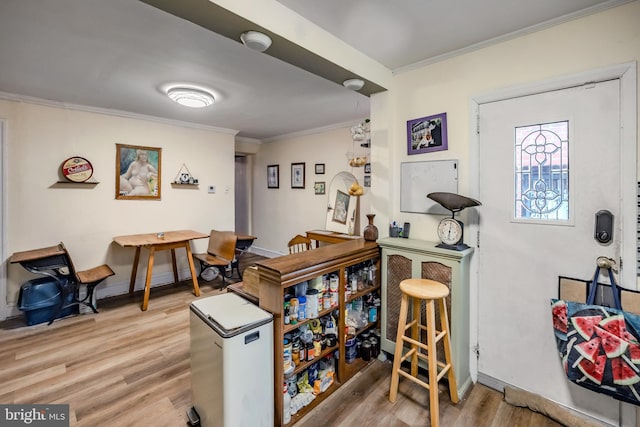 interior space featuring crown molding, stainless steel refrigerator, and light wood-type flooring