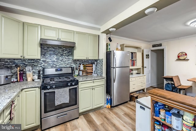 kitchen with light stone counters, green cabinetry, appliances with stainless steel finishes, and light hardwood / wood-style flooring