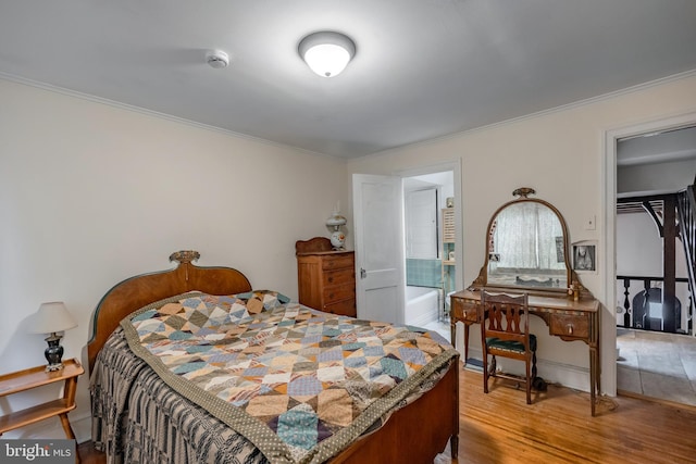 bedroom featuring hardwood / wood-style flooring and ornamental molding