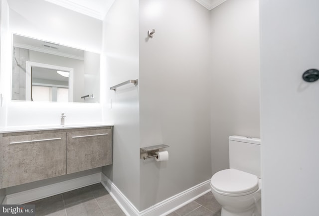 bathroom featuring vanity, ornamental molding, tile patterned floors, and toilet