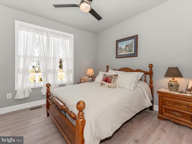 bedroom with light hardwood / wood-style floors and ceiling fan