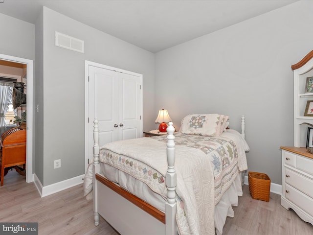 bedroom featuring light hardwood / wood-style floors and a closet