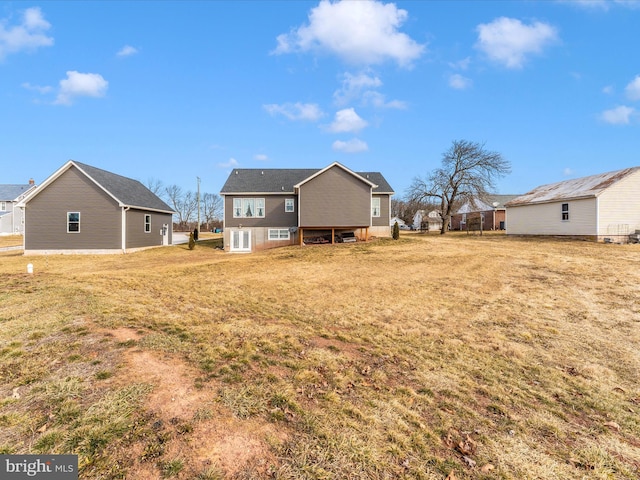 back of property featuring a yard