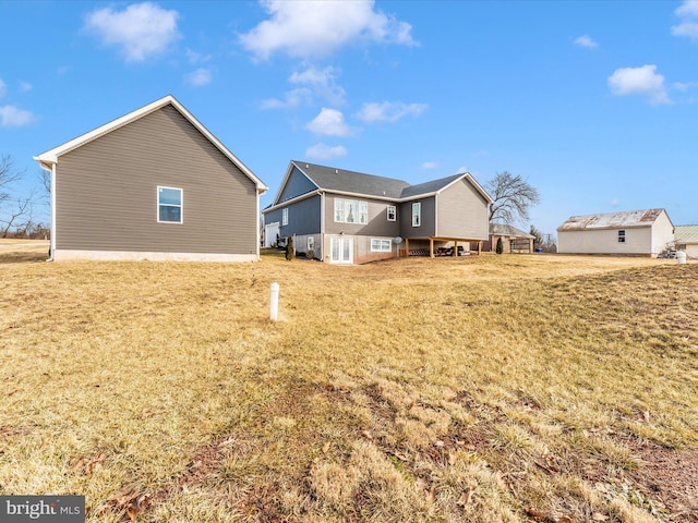 rear view of property featuring a lawn