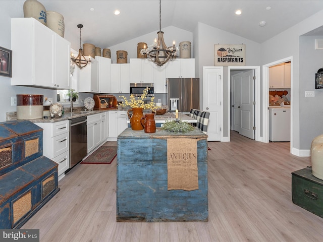 kitchen with a chandelier, stainless steel appliances, pendant lighting, and a center island