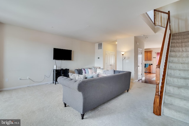 living room featuring light carpet