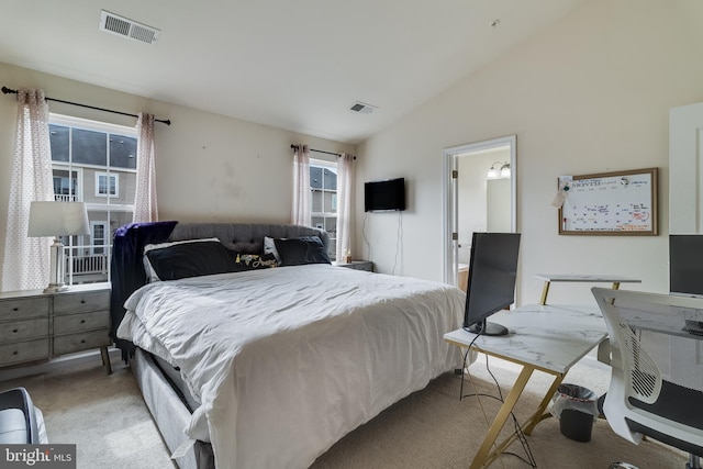 carpeted bedroom featuring ensuite bathroom and vaulted ceiling