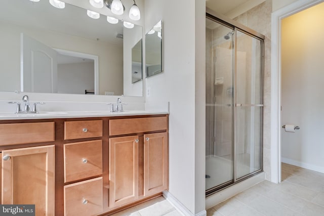 bathroom with tile patterned floors, vanity, and an enclosed shower