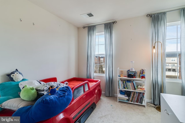 bedroom featuring light carpet