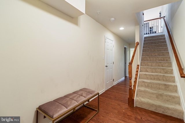 stairs featuring hardwood / wood-style floors