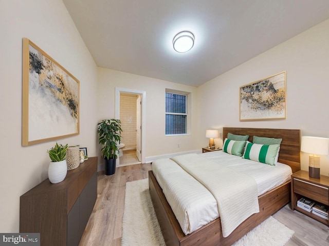1821 T St NW, Washington, DC 20009 - bedroom with light wood-type flooring, ensuite bath, and baseboards
