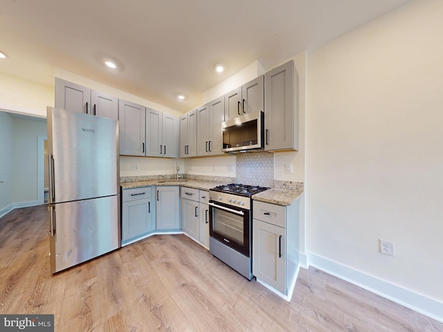 1821 T St NW, Washington, DC 20009 - kitchen with baseboards, stainless steel appliances, and light wood-style floors