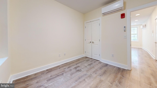 1821 T St NW, Washington, DC 20009 - unfurnished bedroom with baseboards, recessed lighting, light wood-style flooring, and a wall unit AC