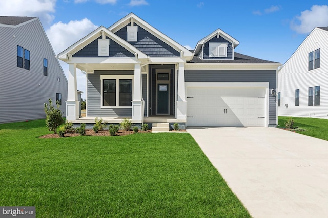 craftsman-style house featuring a porch, a garage, and a front lawn