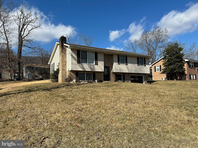 raised ranch with a front lawn