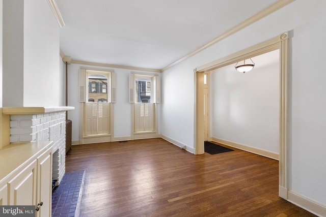 unfurnished living room featuring ornamental molding and dark hardwood / wood-style floors