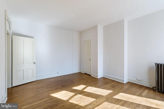 interior space featuring radiator and light hardwood / wood-style floors