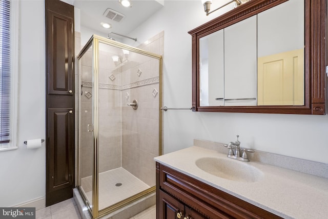 bathroom with vanity, tile patterned floors, and walk in shower