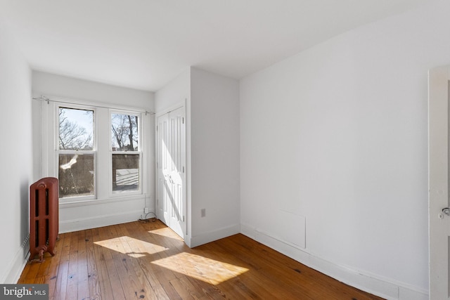 interior space with radiator and light hardwood / wood-style floors