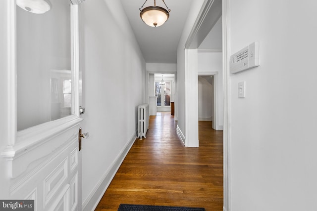 hall featuring dark wood-type flooring and radiator