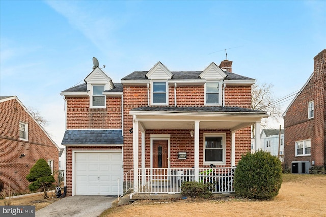 view of front of house with central AC, a garage, and covered porch