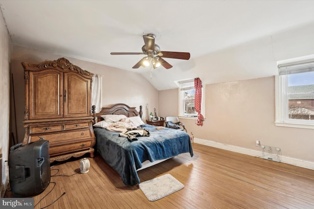 bedroom with lofted ceiling, ceiling fan, and light wood-type flooring