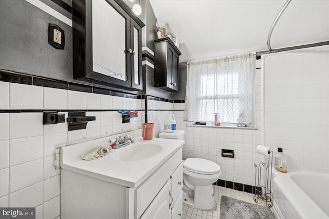 full bathroom with tile patterned floors, toilet, tub / shower combination, tile walls, and vanity