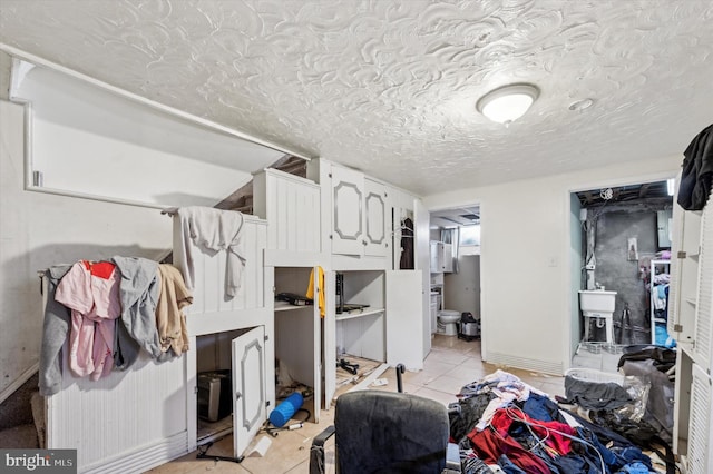 interior space featuring a textured ceiling and light tile patterned floors