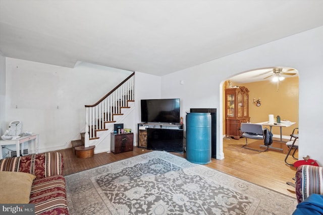 living room featuring ceiling fan and hardwood / wood-style floors