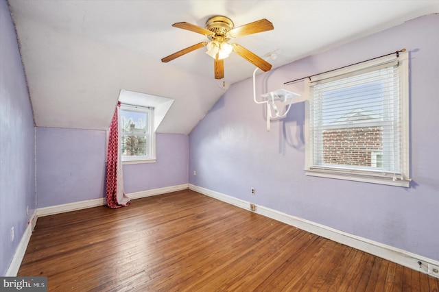 additional living space with hardwood / wood-style flooring, vaulted ceiling, and ceiling fan