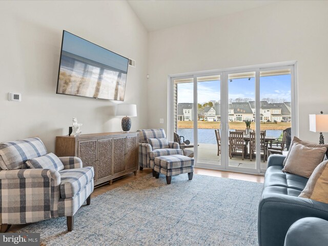 living room with lofted ceiling and light hardwood / wood-style flooring