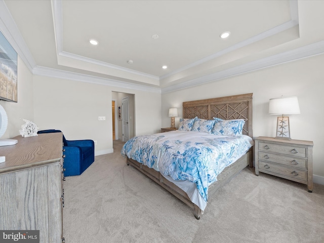 carpeted bedroom featuring ornamental molding and a raised ceiling