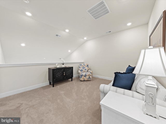 sitting room with lofted ceiling and light carpet