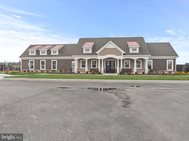 view of front of home with french doors and a front lawn
