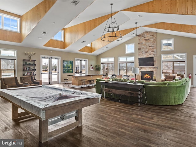 recreation room with dark hardwood / wood-style floors, high vaulted ceiling, a fireplace, pool table, and french doors