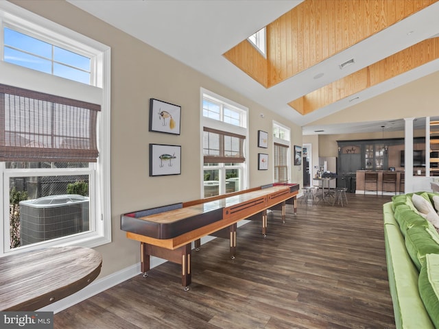 rec room with dark hardwood / wood-style flooring and high vaulted ceiling