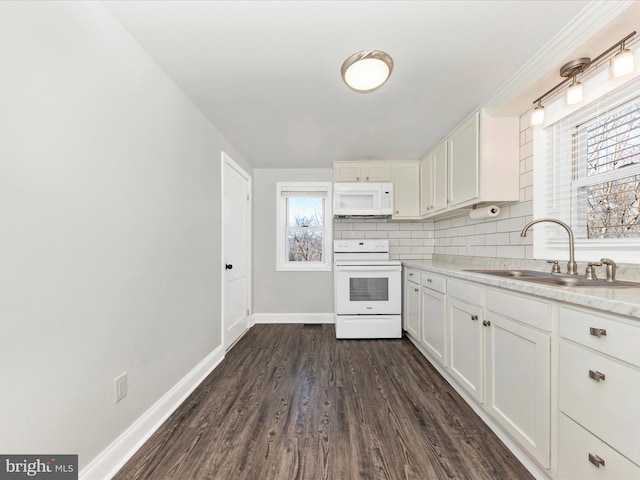 kitchen with white appliances, decorative backsplash, light countertops, white cabinetry, and a sink