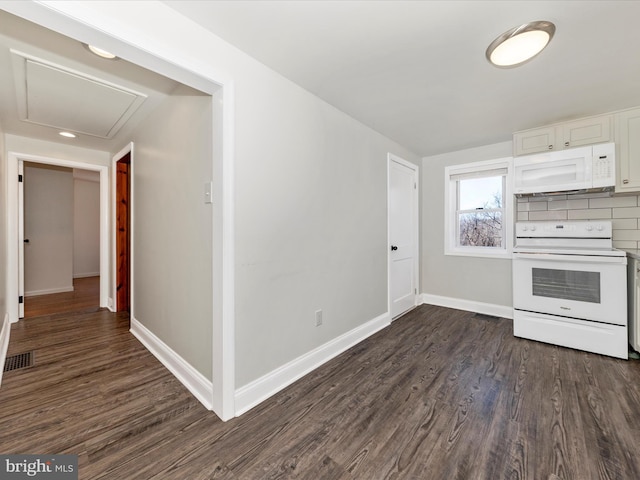 kitchen with white appliances, visible vents, baseboards, white cabinetry, and dark wood finished floors